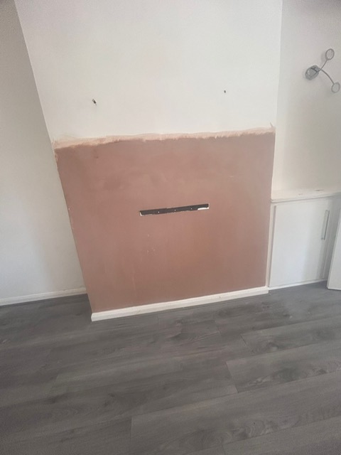 A lower wall rendered after damp proof course injection