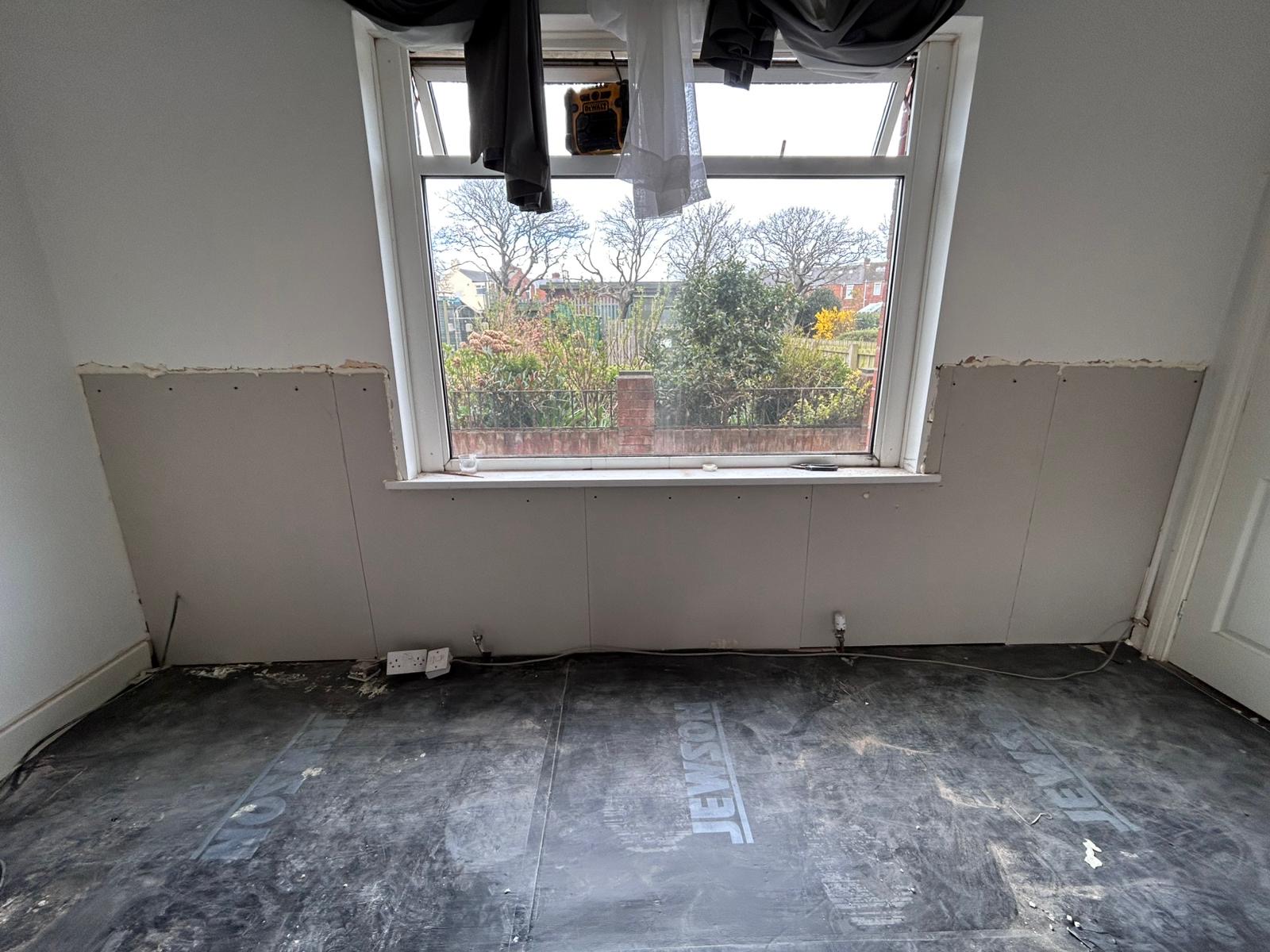 Skimmed walls drying around a window after replastering
