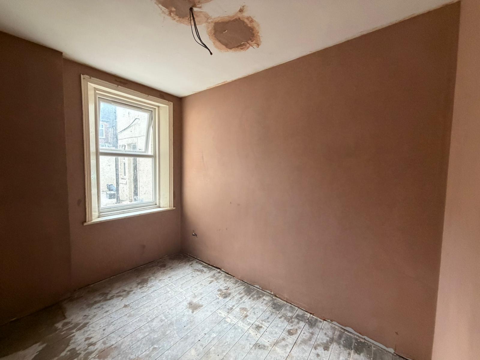 A full wall replastered with a render coat and the ceiling made good