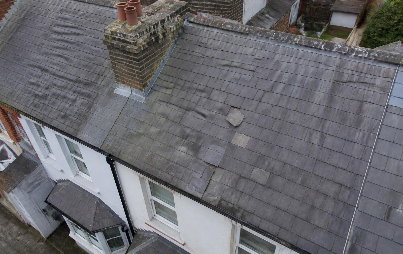 An aerial view over rooftops during a survey of external defects